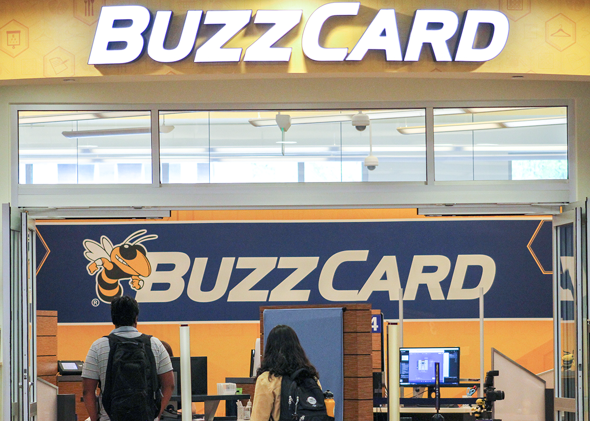 Two students at the entrance of the BuzzCard Center.